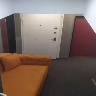 a living room with a couch and a white door at Valeron Suit Premium in Istanbul