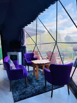 a room with purple chairs and a table and a window at ME-GA Glamping in Sapanca