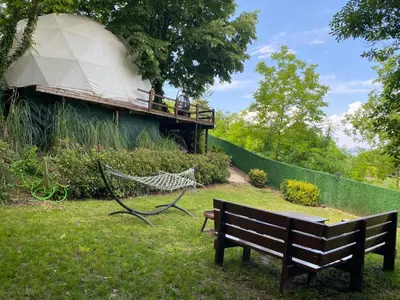 a park bench and a hammock in the grass at ME-GA Glamping in Sapanca