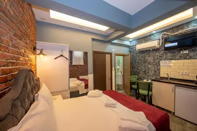a bedroom with a bed and a brick wall at Taksim Story Residence in Istanbul