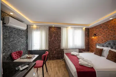 a hotel room with a bed and a table and chairs at Taksim Story Residence in Istanbul