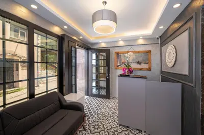 a living room with a couch and some windows at Taksim Story Residence in Istanbul