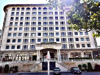 a large white building with cars parked in front of it at İstanbul Houses Sabiha Gökçen Airport in Istanbul