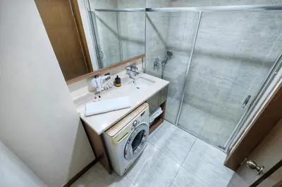 a bathroom with a washing machine and a shower at İstanbul Houses Sabiha Gökçen Airport in Istanbul