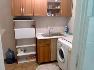 a small kitchen with a sink and a washing machine at 2 bedrooms central area located appartment 1floor in Istanbul