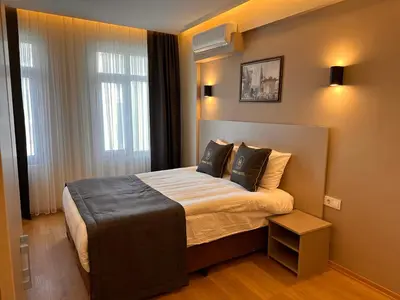 a hotel room with a bed and a window at HARRAN HOTEL in Istanbul