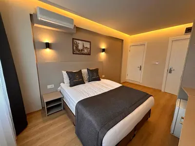 a bedroom with a large bed in a room at HARRAN HOTEL in Istanbul