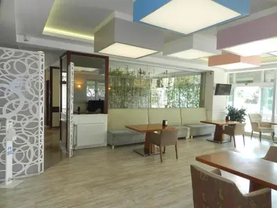 a restaurant with wooden tables and chairs and tables and tablesktop at Sefa Hotel 2 Çorlu in Corlu