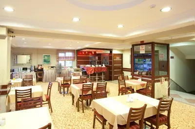 a restaurant with tables and chairs and a bar at Sefa Hotel 2 Çorlu in Corlu