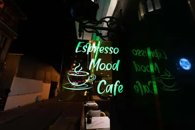 a neon sign for an espresso mood cafe on a building at Costera Hotel in Istanbul