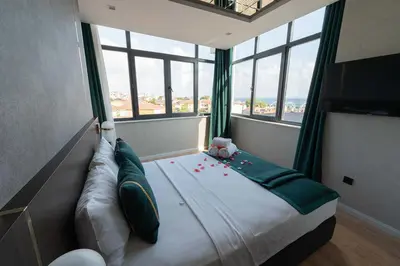 a bedroom with a bed with a large window at Costera Hotel in Istanbul
