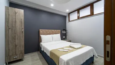 a bedroom with a bed with two towels on it at KUMBAĞ ŞEHRİ SARAY APART OTEL in Tekirdag