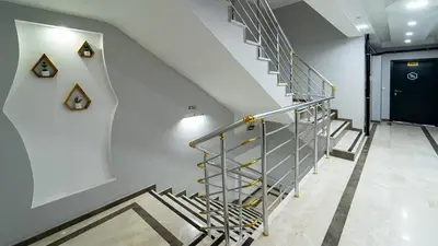 a staircase in a building with a black door at KUMBAĞ ŞEHRİ SARAY APART OTEL in Tekirdag