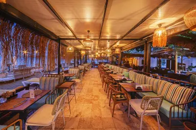 a row of tables and chairs in a restaurant at KİRAZ BEACH OTEL in Erdek