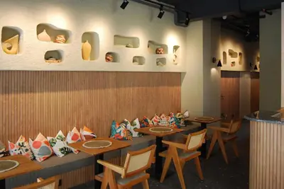 a restaurant with wooden tables and chairs and shoes on the wall at Four Sides Beyoglu in Istanbul