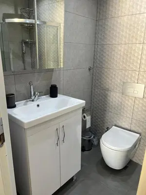 a bathroom with a white sink and a toilet at Middle Village in Istanbul