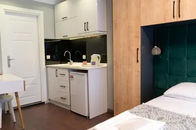 a small bedroom with a bed and a kitchen at Middle Village in Istanbul