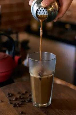 a person pouring coffee into a cup on a table at Sunlight Hotel in Istanbul