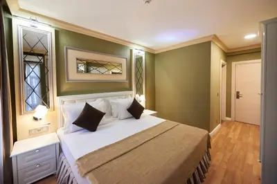 a bedroom with a large bed with green walls at Sunlight Hotel in Istanbul