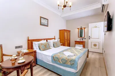 a bedroom with a bed and a small table at Hotel Saba in Istanbul