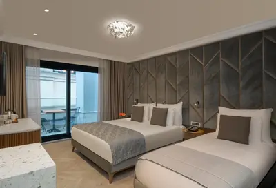 a hotel room with two beds and a window at Hotel Nena Sultanahmet in Istanbul