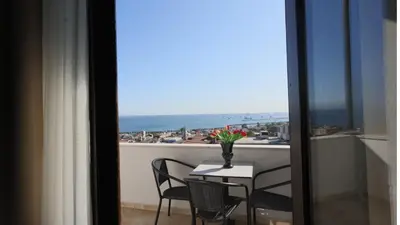 a table and chairs with a view of the ocean at Olimpic Hotel in Istanbul