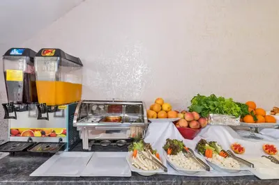 a buffet with food and a drink on a counter at Olimpic Hotel in Istanbul