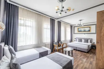 a hotel room with two beds and a table at Sur Hotel Sultanahmet in Istanbul