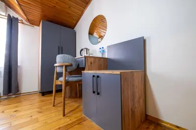a small kitchen with a chair and a refrigerator at Sur Hotel Sultanahmet in Istanbul
