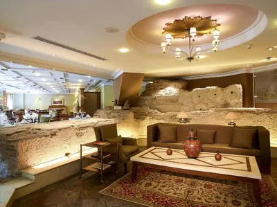 a lobby with a couch and a stone wall at Eresin Hotels Sultanahmet - Boutique Class in Istanbul