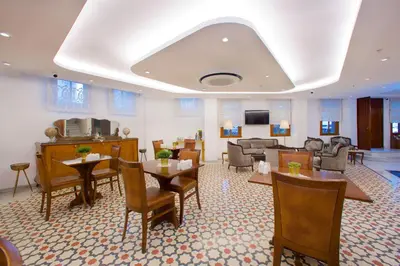 a waiting room with a piano and tables and chairs at Yusufpasa Konagi - Special Class in Istanbul