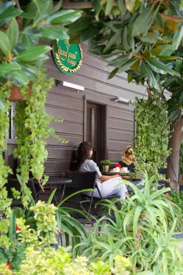 two women sitting at a table in front of a building at Yusufpasa Konagi - Special Class in Istanbul