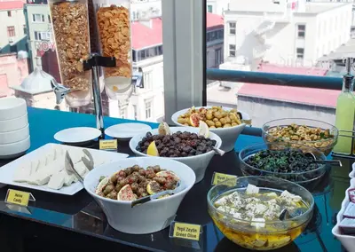 a table topped with bowls of food on a table at Hotel Troya in Istanbul