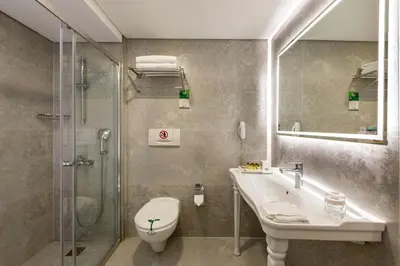 a bathroom with a toilet and a sink and a shower at Hotel Yasmak Sultan in Istanbul
