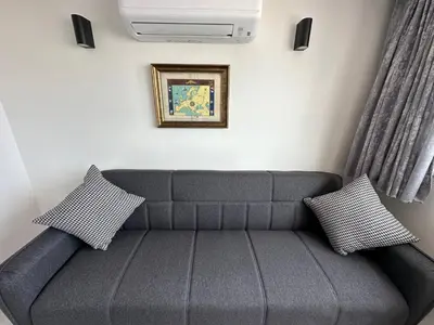 a living room with a couch and a tv at Hanedan Hotel in Istanbul