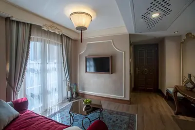 a living room with a couch and a large window at Romance Istanbul Hotel Boutique Class in Istanbul