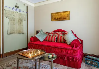 a living room with a red couch and a table at Romance Istanbul Hotel Boutique Class in Istanbul
