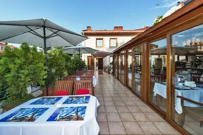 a restaurant with tables and umbrellas on a patio at Zeynep Sultan Hotel in Istanbul
