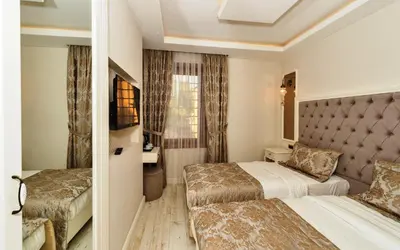 a hotel room with two beds and a window at Zeynep Sultan Hotel in Istanbul
