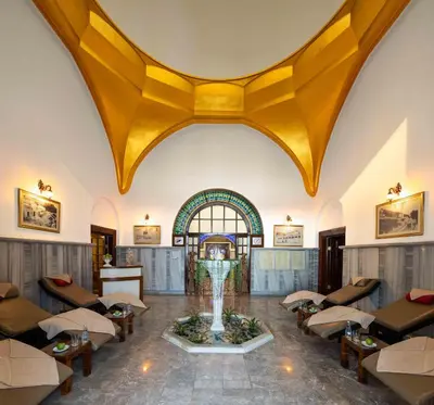 a lobby with a large yellow ceiling and a fountain at Hotel Çelik Palas Convention Center & Thermal SPA in Bursa