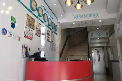 a lobby with a red counter and a staircase at Star Holiday Hotel in Istanbul