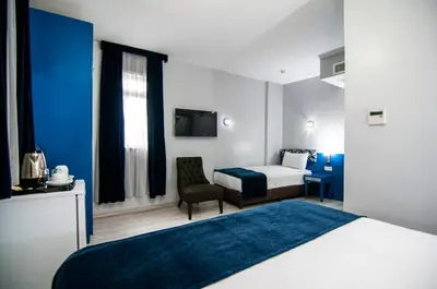 a hotel room with a bed and a chair at Lapis Inn Hotel & Spa ( Ex. Ambassador Hotel) in Istanbul