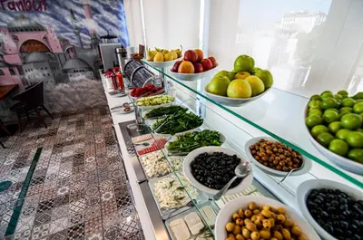 a buffet line with bowls of fruit and vegetables at Lapis Inn Hotel & Spa ( Ex. Ambassador Hotel) in Istanbul