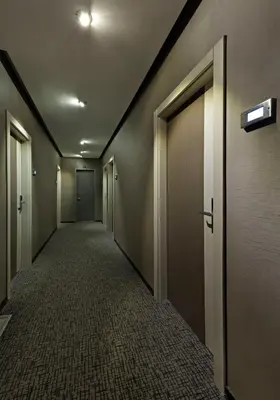 an empty hallway with doors and carpeted floors at Lapis Inn Hotel & Spa ( Ex. Ambassador Hotel) in Istanbul