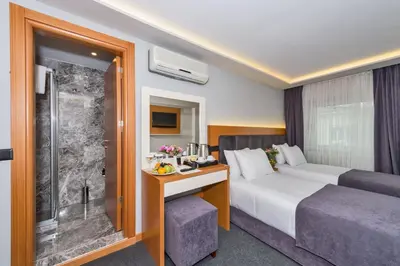a hotel room with a bed and a shower at Bergama Hotel Old City in Istanbul
