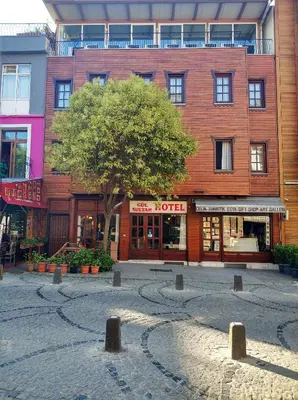 a large brick building with a tree in front of it at Gul Sultan Hotel in Istanbul
