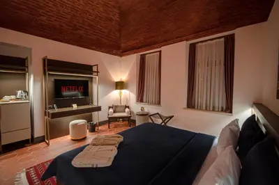 a bedroom with a large bed with a television in it at Han 1772 Hotel in Istanbul