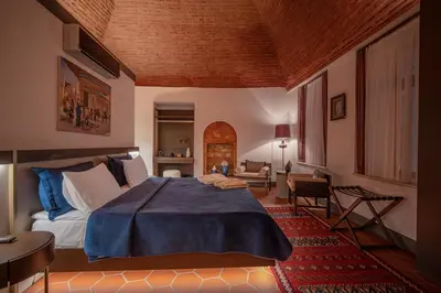 a bedroom with a bed and a living room at Han 1772 Hotel in Istanbul