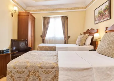 a hotel room with two beds and a window at Best Western Empire Palace Hotel & Spa in Istanbul