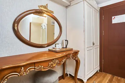 a dressing room with a mirror and a dressing table at Best Western Empire Palace Hotel & Spa in Istanbul